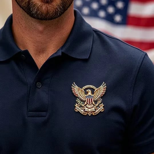 Patriotic brooch on navy polo shirt